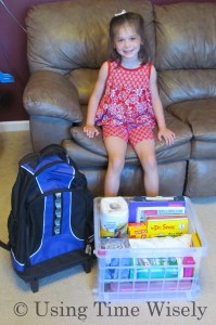 Kindergartener with school supplies